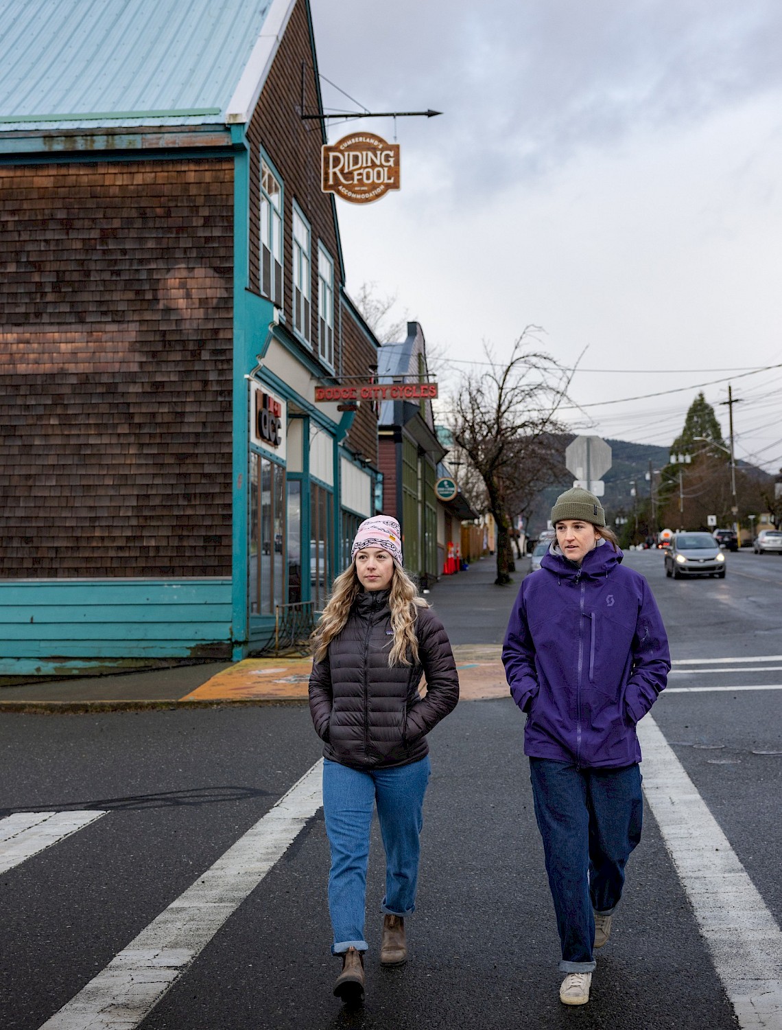Two people walking on a crosswalk in downtown Cumberland, BC