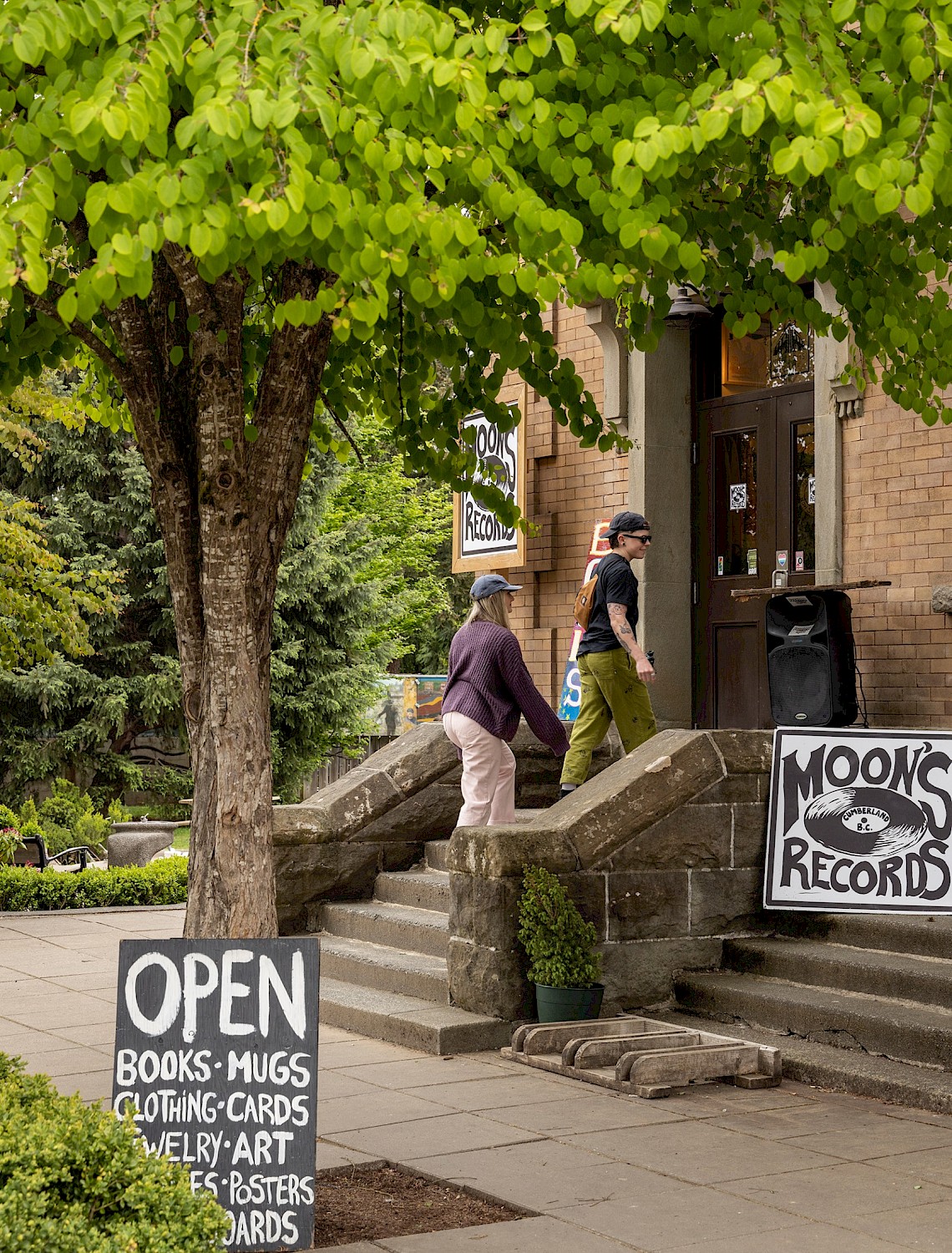 Two people entering a store in downtown Cumberland, BC